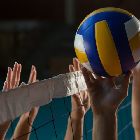 Cropped hands of players practicing volleyball at court